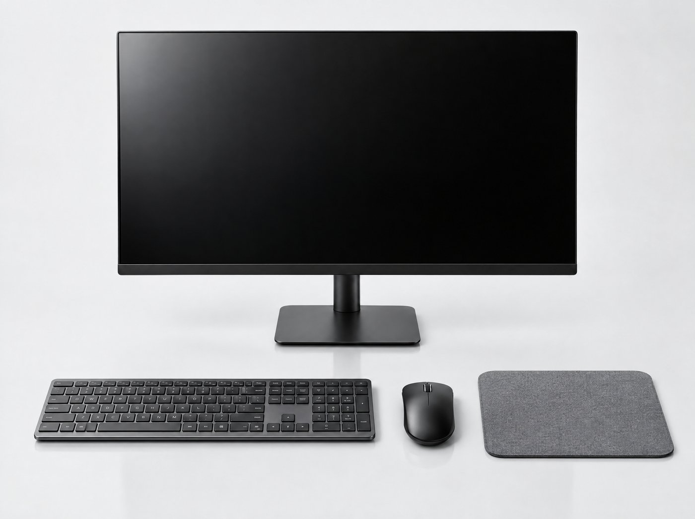 A monitor shown with a matching wireless keyboard, mouse and mouse mat as cross-sell items